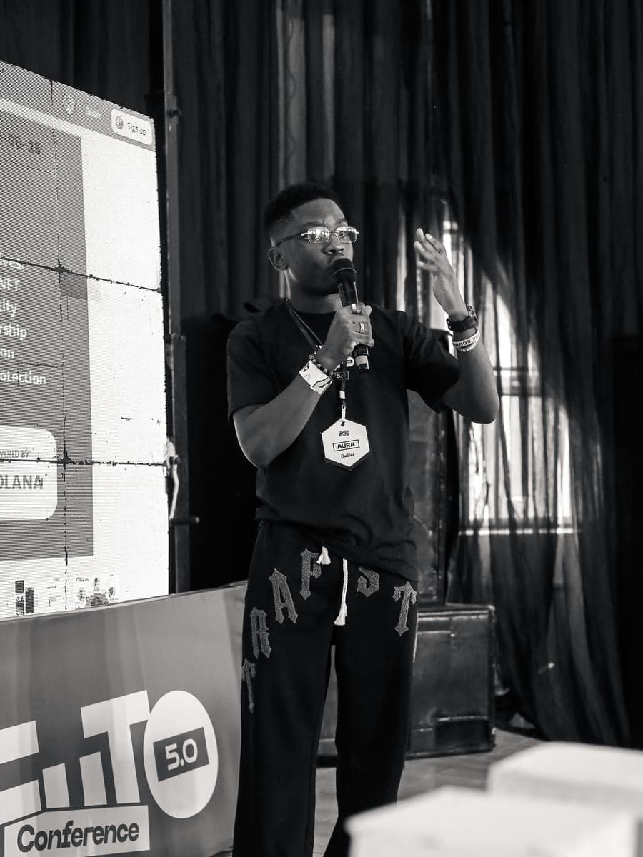 Jackson mid-pitch at the F.iTO 5.0 conference stage, in black and white